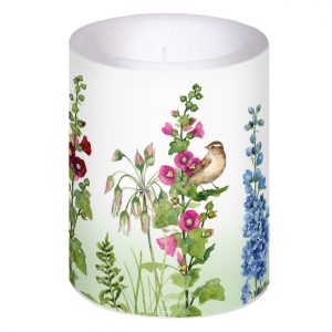 Una vela blanca con ilustraciones florales coloridas y un pájaro posado entre las flores.