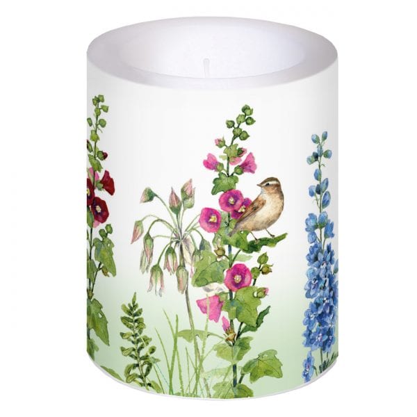 Una vela blanca con ilustraciones florales coloridas y un pájaro posado entre las flores.
