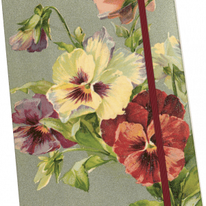 Un cuaderno con diseño floral, con pensamientos amarillos y rojos, y una banda elástica de color granate.