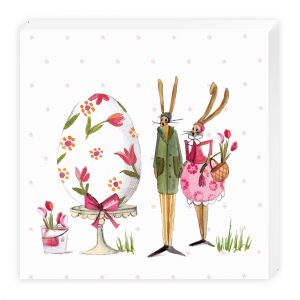 Ilustración de dos conejos con orejas largas junto a un gran huevo decorado. Un conejo sostiene una canasta de tulipanes. Cerca hay un pequeño tulipán en maceta sobre el césped.