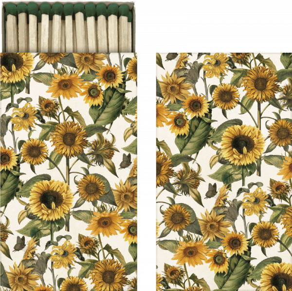 Dos paneles con un diseño floral con girasoles y hojas verdes. El panel izquierdo es una caja de cerillas abierta con el mismo diseño floral.