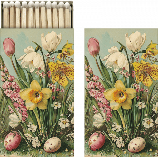 Una caja de cerillas abierta que presenta un diseño floral con tulipanes, narcisos y huevos moteados en la tapa.