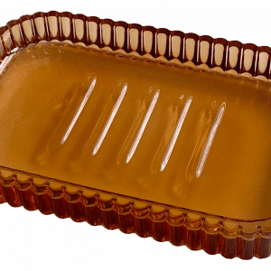 Jabonera de vidrio de color ámbar, rectangular, con bordes acanalados y cinco ranuras en la base.