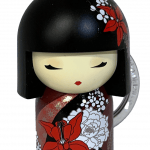 Llavero que presenta una muñeca con un corte de pelo bob negro, un vestido floral rojo y blanco y ojos cerrados.