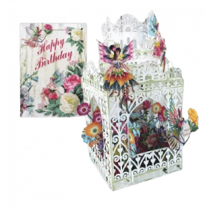 El 3D017 HADAS DE LAS FLORES es un intrincado farolillo de papel blanco decorado con coloridas flores e ilustraciones de hadas, que se muestra junto a una tarjeta floral de "Feliz cumpleaños".