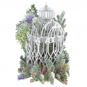 La JAULA DE PLANTAS 3D047 presenta una jaula de pájaros blanca y ornamentada rodeada de suculentas de papel y vegetación sobre un fondo blanco.