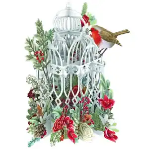 Una jaula de pájaros blanca rodeada de flores rojas y blancas, plantas y bayas, con un petirrojo posado en la jaula.