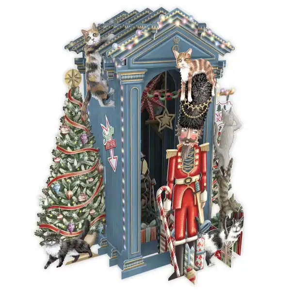 Ilustración de una festiva escena navideña con un árbol decorado, un cascanueces, cajas de regalo y cinco gatos subidos y alrededor de una estructura de vigilancia azul adornada con luces y guirnaldas.